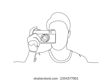 A man takes a picture with a focus. World photography day one-line drawing