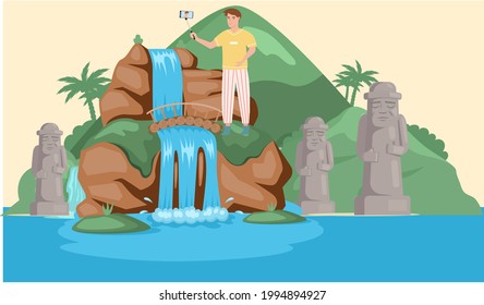 Man takes selfie stands near lake in mountaines landscape with waterfall. Traveler photographing famous landmark in beautiful island in summer vacation. Tourist attraction of wonderful place of visit