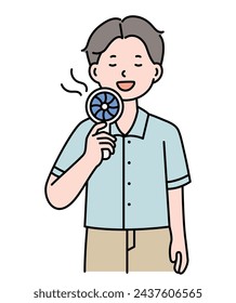 A man is taking in the air with a portable fan.