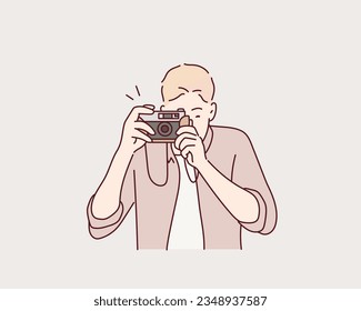  man taking photos with vintage camera outdoor. Hand drawn style vector design illustrations.