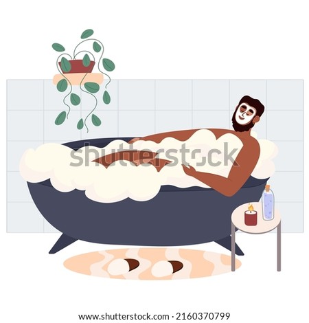 Man taking a relaxing bubble bath and taking care of himself