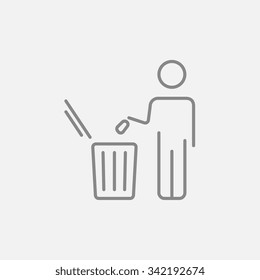Man throwing garbage in a bin line icon for web, mobile and infographics. Vector dark grey icon isolated on light grey background.