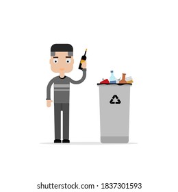 A man throwing a glass bottle into a recycling bin.