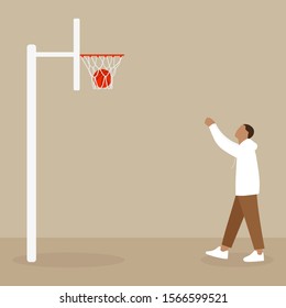 A man throws a ball into a basketball hoop