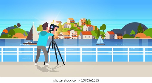 man travel photographer taking nature picture of mountain city island guy using dslr camera on tripod landscape background horizontal