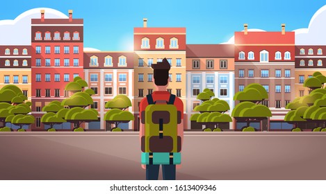 man traveler walking outdoor enjoying view of modern town buildings summer trip vacations concept rear view tourist with backpack sightseeing architecture city street horizontal portrait vector