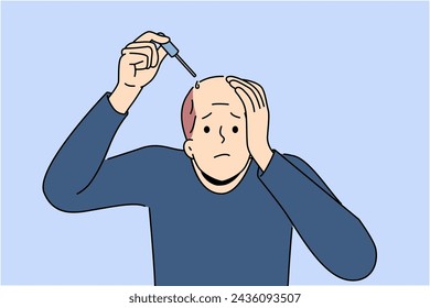 Man treats baldness with dropper of doctor-recommended healing oil that improves hair growth and makes him look attractive. Problem of baldness worries adult guy during midlife crisis
