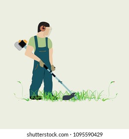 A man with a trimmer cuts grass on a white background. A man in overalls cuts grass with a trimmer. Worker cutting grass in garden with the weed trimmer.