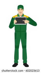 Man in uniform pointing at blank digital tablet PC. Full length portrait of Delivery man or Worker in a flat style. Vector illustration.
