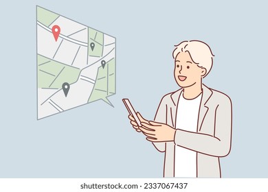 Man uses navigator on phone and builds route on map or looks for location of institution of interest. Guy with mobile navigator is exploring new city or booking place to visit via internet