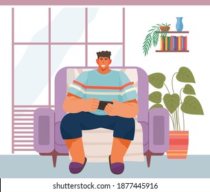 Man uses the phone for entertainment. Male character relaxing on the couch on the weekend and using a modern electronic device. Person has fun in his free time with the help of modern technologies