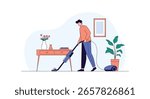Man uses vacuum cleaner to clean floor in modern room with plants and furniture