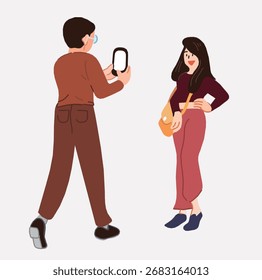 Ein Mann benutzt sein Mobiltelefon, um ein Foto von einer Frau zu machen.