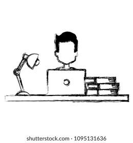 man using laptop with books and lamp