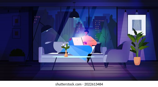 man using laptop in dark night living room social media network online communication concept