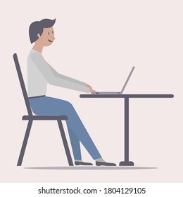 Hombre usando una laptop sentado en una silla