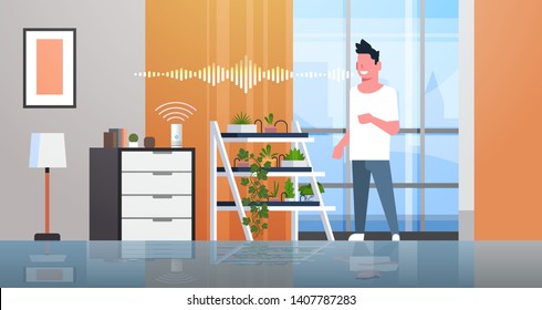 man using smart speaker voice recognition activated digital assistants concept auto watering system modern living room interior flat horizontal full length