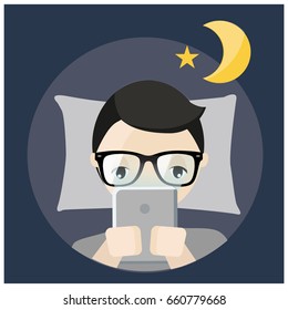 man using tablet before bed time.young cell phone addict man awake at night in bed using tablet.