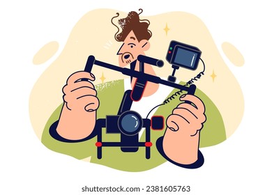 Man videographer holds camera mounted on stabilizer to shoot video with smooth frame movement. Young guy professional videographer, uses expensive equipment while working on movie.