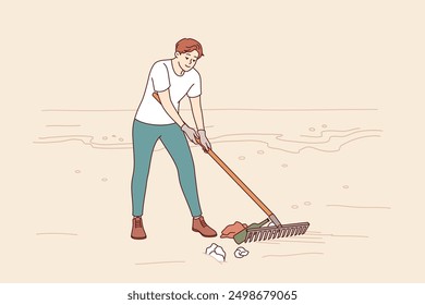 Man volunteer cleans beach of trash to prevent ocean pollution from plastic and bottles. Guy is volunteer trying to save nature and environment from pollution causing climate change.
