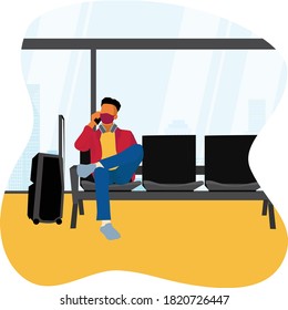 A man waiting for the airplane at the airport waiting room