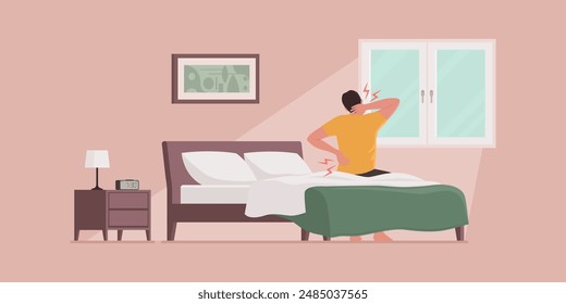 Man waking up and suffering from back pain, he is sitting on the bed and touching his neck and lower back