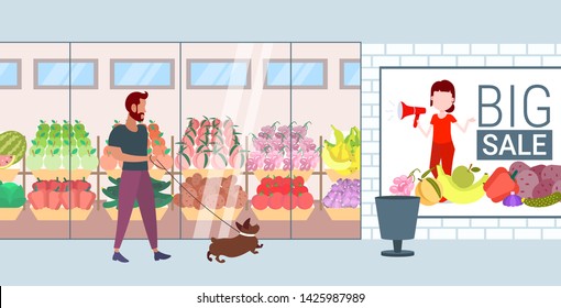 man walking with dog guy and his pet having fun in front of supermarket mall grocery shop exterior flat full length horizontal