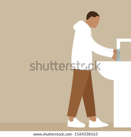 A man washes his hands under the tap with water
