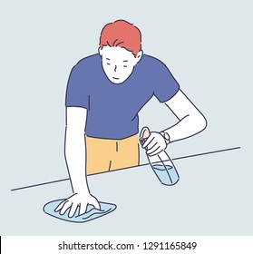 A man is washing his desk with detergent and a rag. hand drawn style vector design illustrations.