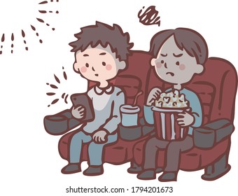 A man watching a smartphone during a movie screening