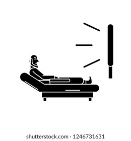 Man watching tv black icon, vector sign on isolated background. Man watching tv concept symbol, illustration 