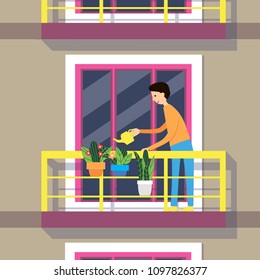 
man watering flowers on the balcony of the apartment building
