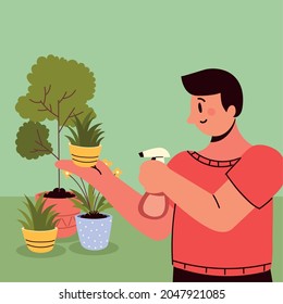 man watering houseplants with spray