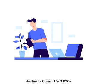 A man watering plants in his office at home