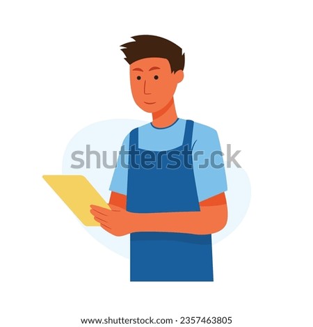Man wearing apron using tablet