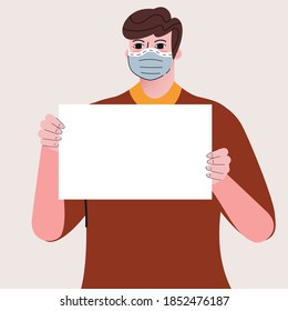 A man is wearing a face mask and holding a placard.