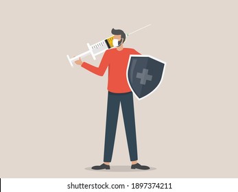  a man wearing a face mask holds a shield and injects the coronavirus vaccine, time to vaccinate concept