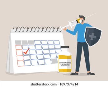 man wearing a face mask standing next to the calendar holds a shield and injects the coronavirus vaccine, time to vaccinate concept
