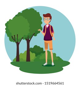 man wearing glasses with backapck and trees with bushes