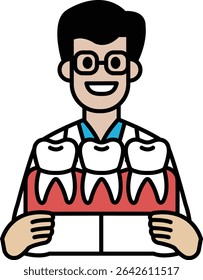 A man in a white lab coat holding a tray of teeth. He is smiling and he is happy