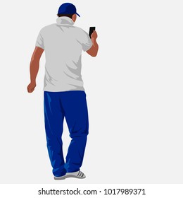 A Man In A White Shirt And Blue Pants Holding A Phone. The Guy Looks At The Phone Screen. The View From The Back.The Isolated Image On A White Background