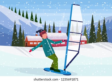 man windboarding windsurfing on snow over small village houses 
