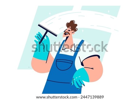 Man window cleaner cleans glass, polishing surface and removing traces of streaks and stains. Guy works as window cleaner, performing disinfection and sanitary cleaning of business premises.