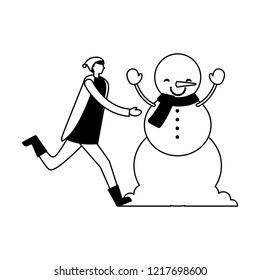 man with winter clothes and snowman