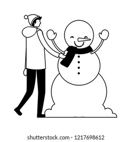 man with winter clothes and snowman
