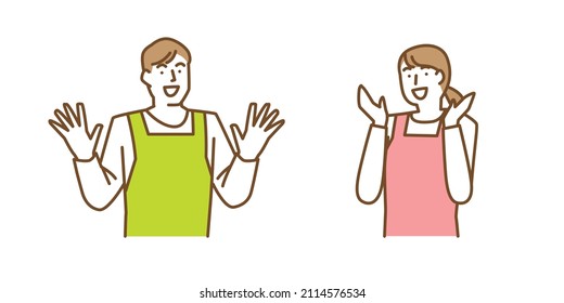 A man and a woman in aprons raise their hands in surprise and joy.