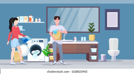 man woman with basket of clothes couple loading laundry to washing machine doing housework housekeeping concept modern bathroom interior cartoon character full length flat horizontal