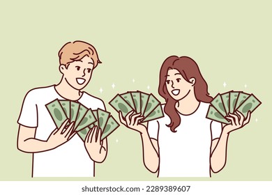 Man and woman with lot of cash in hands brag about money they earned from business or winning jackpot in lottery. Couple rich guys girls with money want to invest savings or invest in startup 