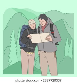 Man and Woman Couple hiking on mountain reading map on vacation