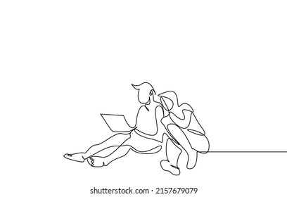 a man and a woman couple sitting outside on the floor and using a computer